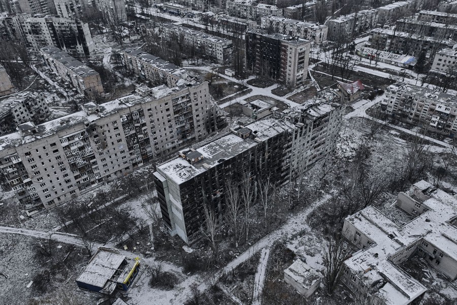 An aerial view of a residential neighborhood with many war-damaged residential buildings