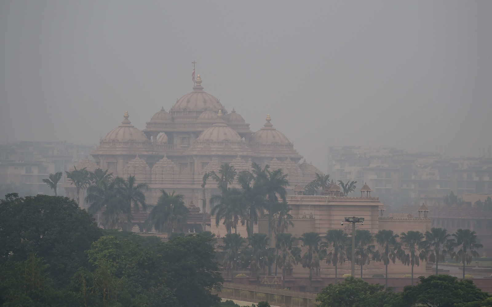 A view of a historic temple and its grounds in smoggy air