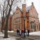 A photo of people walking by a Bowdoin, College campus building. 
