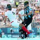 Two football players wearing blindfolds collide while chasing the ball during a match at the Paralympic Games.