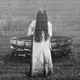 Samara, a girl in a long white dress and with long black hair covering her face, exits a well in "The Ring."