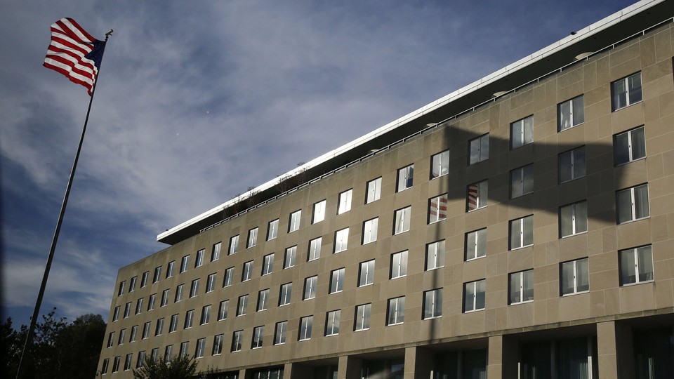 The U.S. flag and its shadow falling on the Harry S. Truman Building at the Department of State