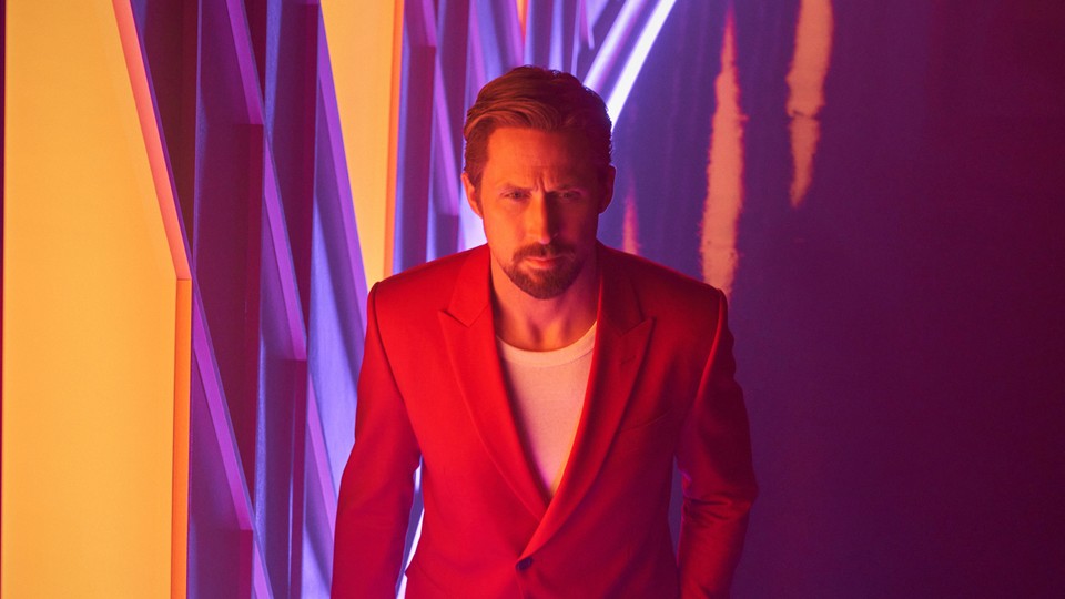 Ryan Gosling in a red suit in front of a vibrant background in "The Gray Man"