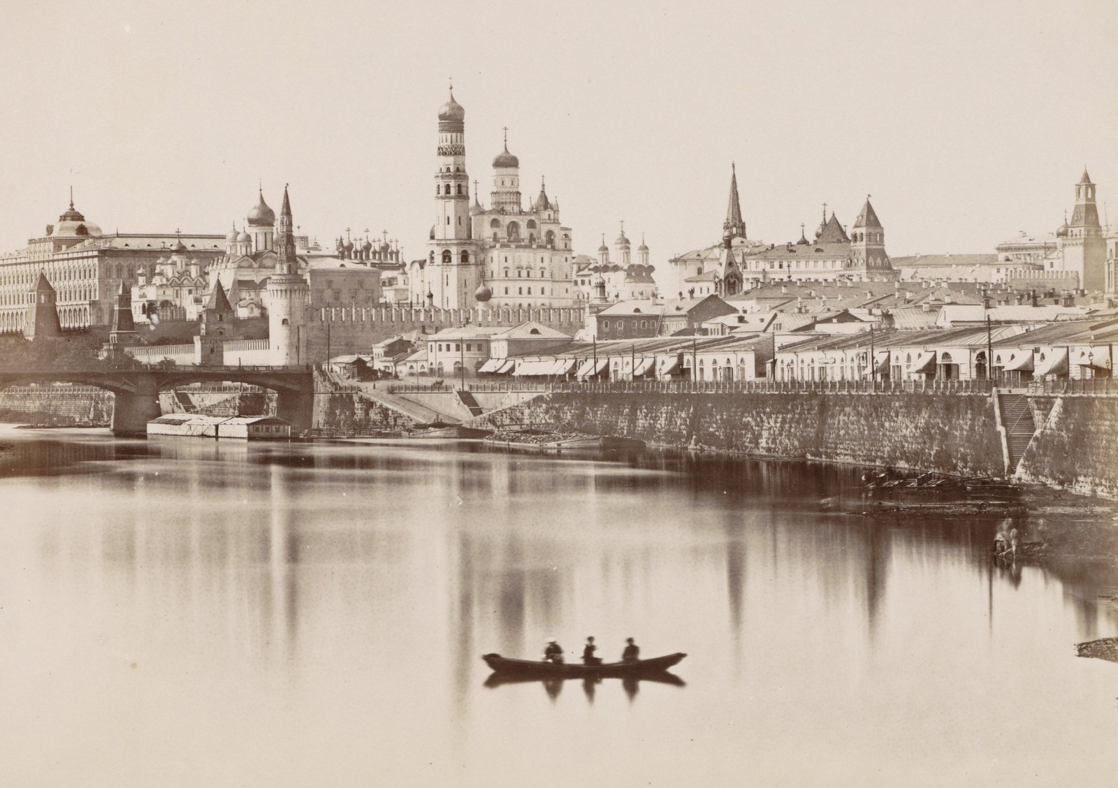 The many historic buildings of Moscow's Kremlin, seen from across a river.