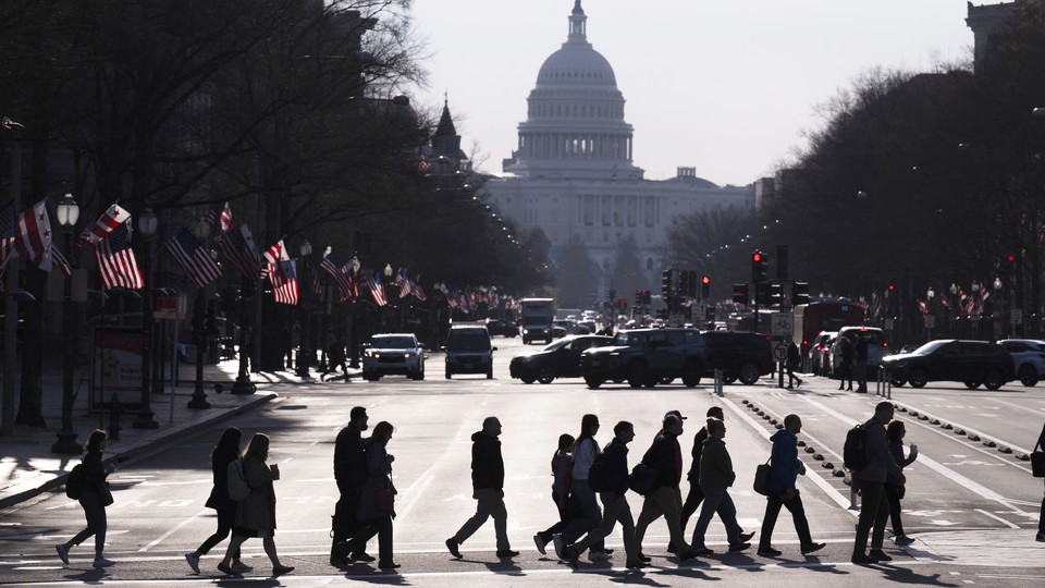 A photo of people going to work in Washington, D.C., with the U.S. Capitol.