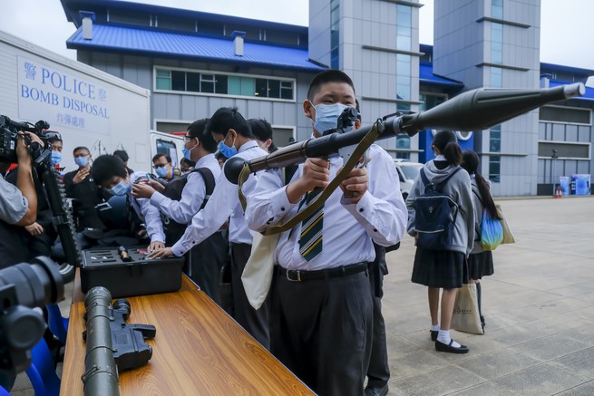 Schoolkids holding rocket launchers