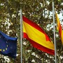 European Union, Spanish, and Catalan flags are seen.