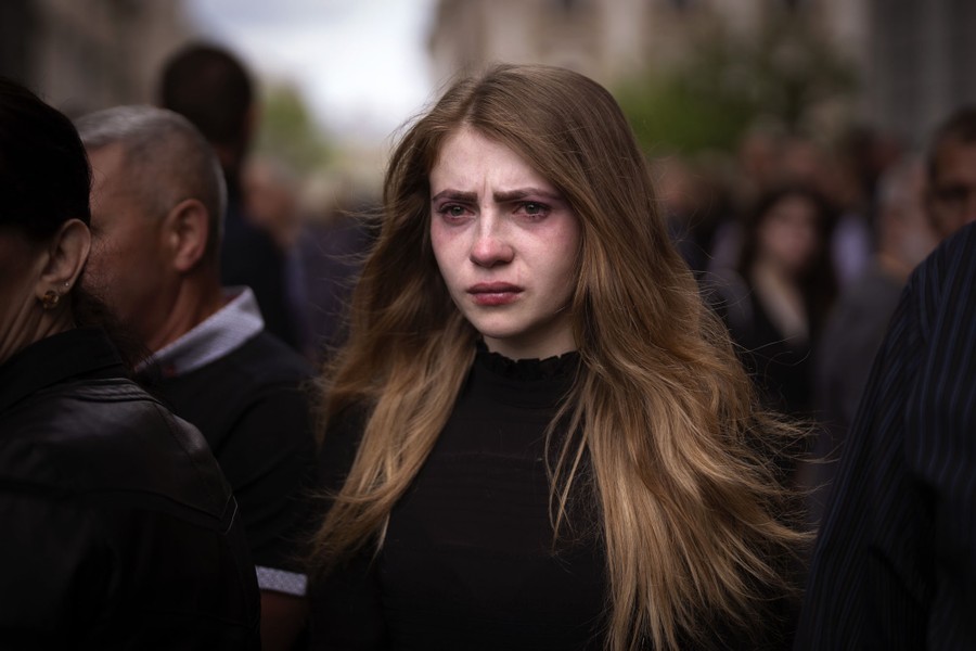 A woman cries during a funeral.