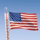 An American flag for which the pole is a thermometer