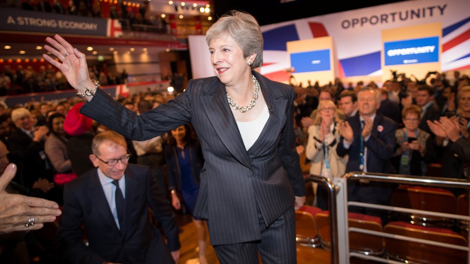 U.K. Prime Minister Theresa May waves to supporters