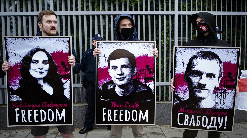 Protestors hold up images of political prisoners