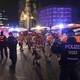 Firefighters walk past ambulances after a truck ran into a crowded Christmas market and killed several people in Berlin on December 19, 2016. 