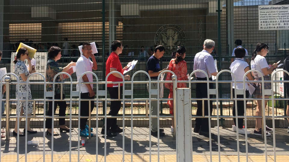 People waiting in line outside the U.S. embassy in Beijing, China on July 26, 2018