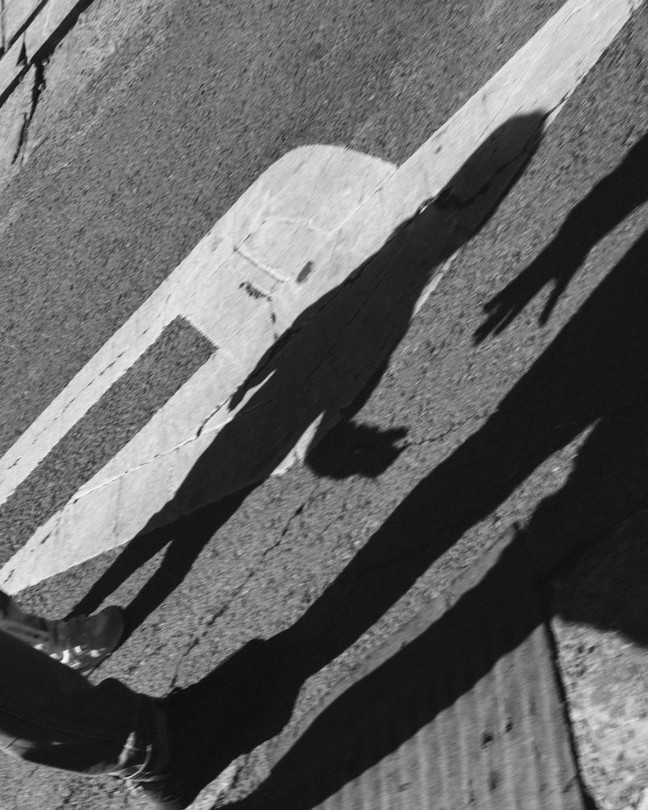 shadow of an adult hand reaching for a child's
