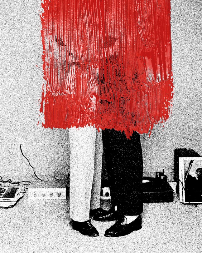 Two people embracing, covered in a stripe of red paint