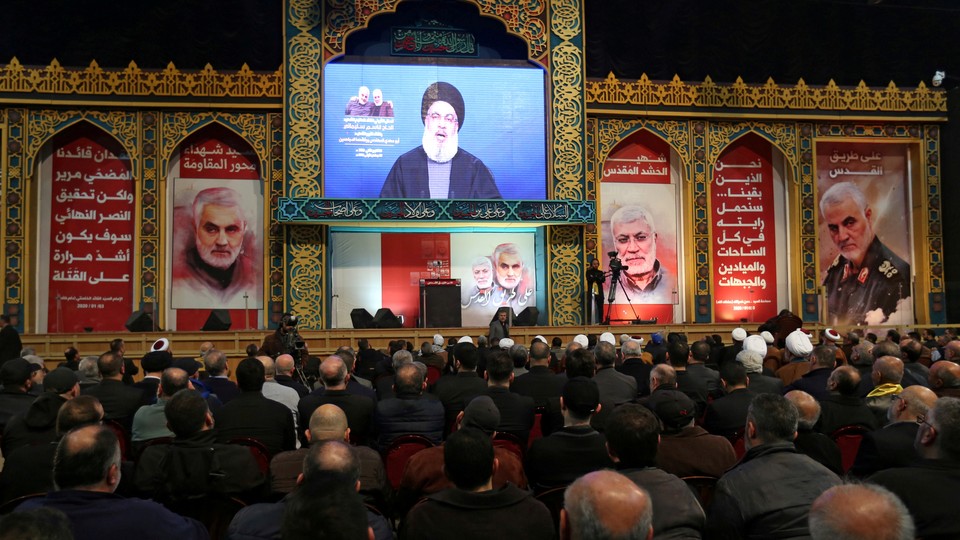 Lebanon's Hezbollah leader Hassan Nasrallah addresses his supporters via a screen during a funeral ceremony rally to mourn Qassem Soleimani.