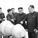 Kim Jong Un looking at machinery with advisers