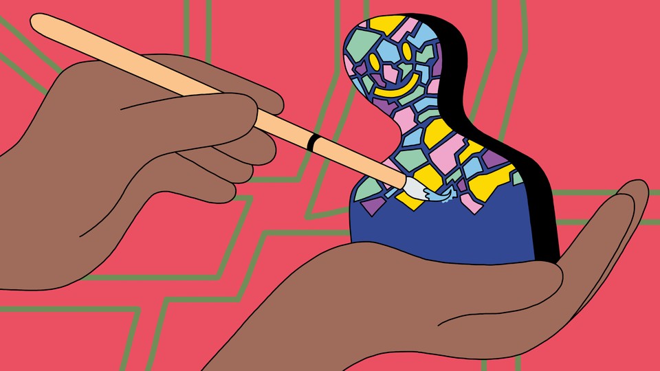 A smiling figurine being painted in an artist's palm