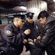 Police officers inspect a bag in a New York subway station.