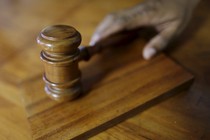 A gavel sits on a desk. 
