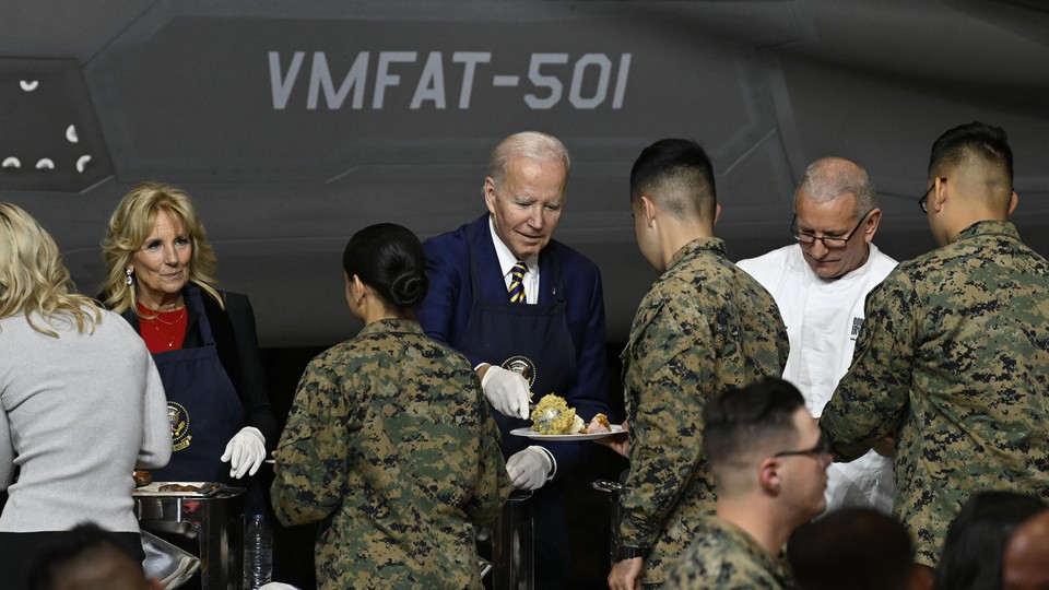 President Joe Biden and First Lady Jill Biden serve food during the Friendsgiving dinner with service members and military families in Havelock, NC on November 21, 2022