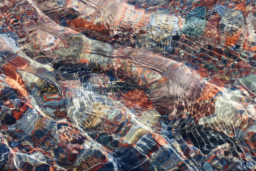 Ripples and swirling colors visible in a small stream