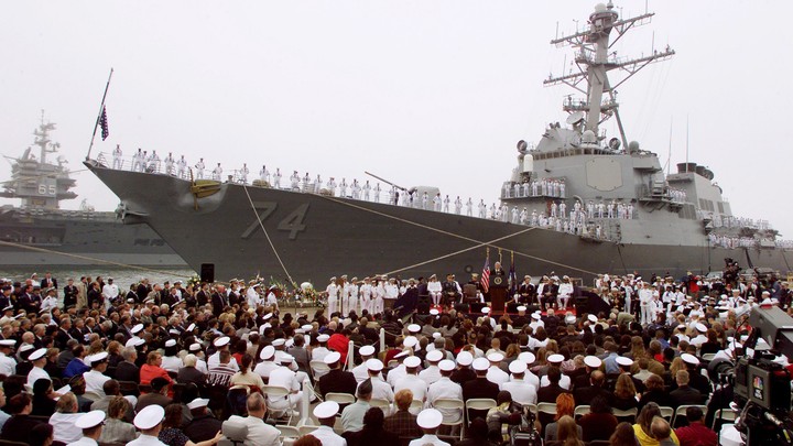 Bill Clinton speaks at a memorial service for the victims of the USS Cole bombing in October 2000.