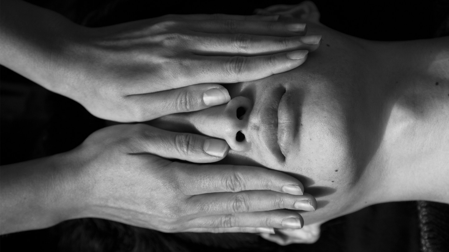 Image of hands on a face