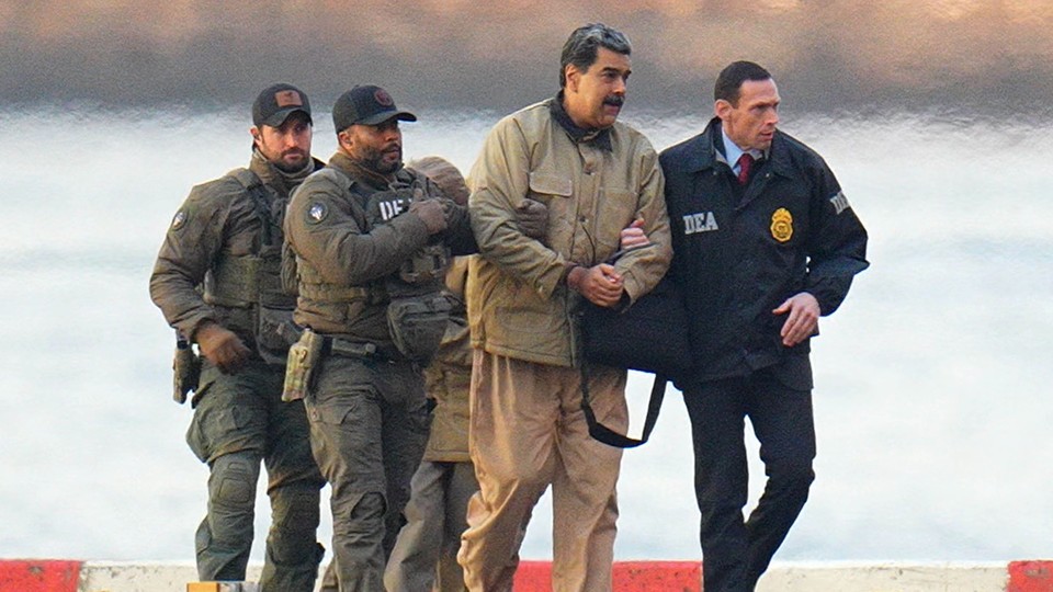 A photo of Nicolas Maduro being escorted by U.S. agents