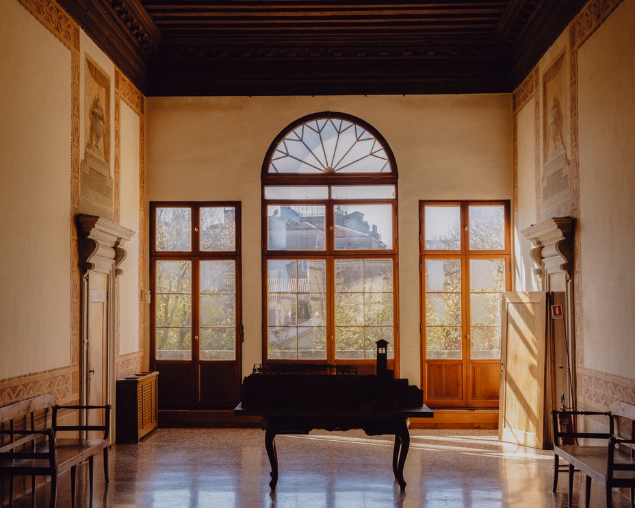 A central hall in the Palazzo Soranzo Cappello with large windows facing the garden