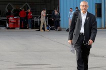 John Podesta, Hillary Clinton's campaign chairman, boards an airplane in White Plains, New York