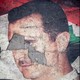 A defaced poster of Bashar al-Assad