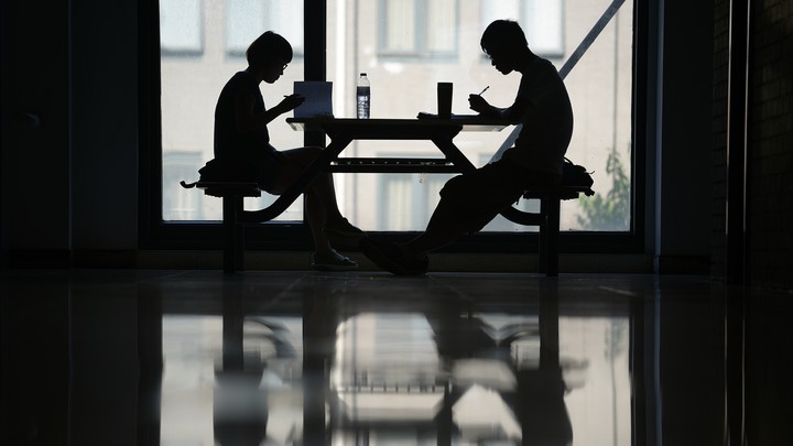 Students working in silhouette
