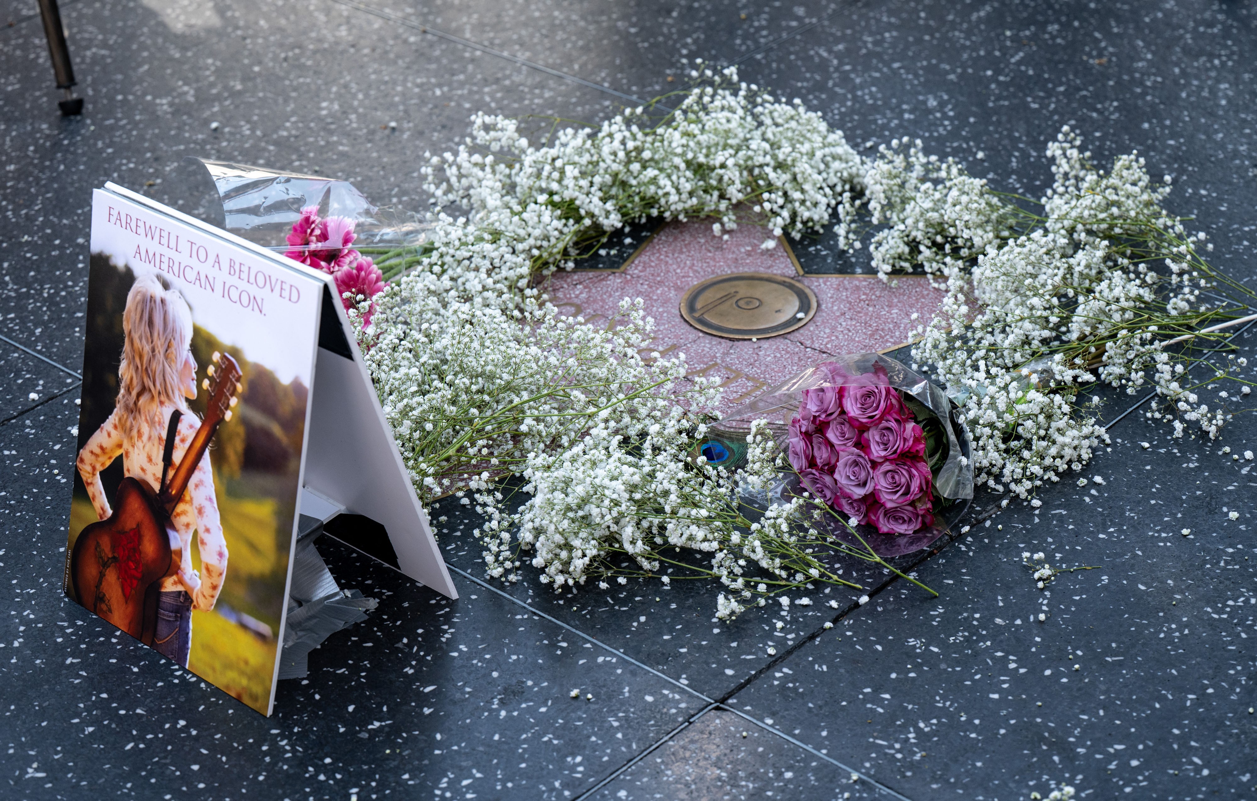 Flowers adorn the star of Dolly Parton on the Hollywood Walk of Fame.