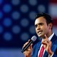 The Republican presidential hopeful Vivek Ramaswamy speaks into a microphone