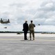 Photo of Donald Trump and an army major general watching two helicopters take off