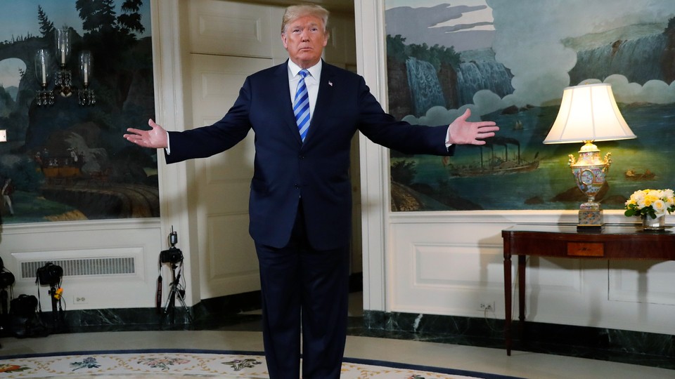 President Trump stands in the White House with arms spread