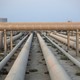 Photograph of a set of industrial pipelines in the desert