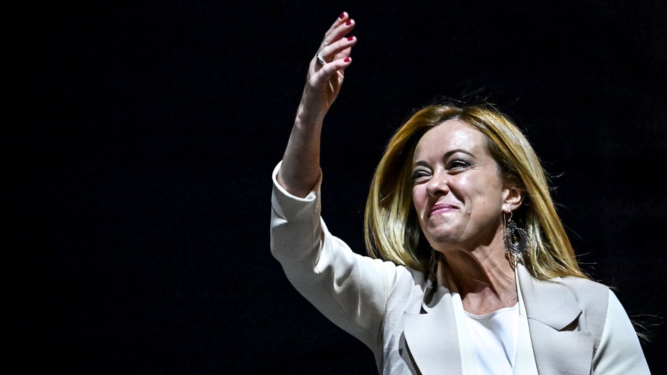 Italian politician Giorgia Meloni smiling and waving
