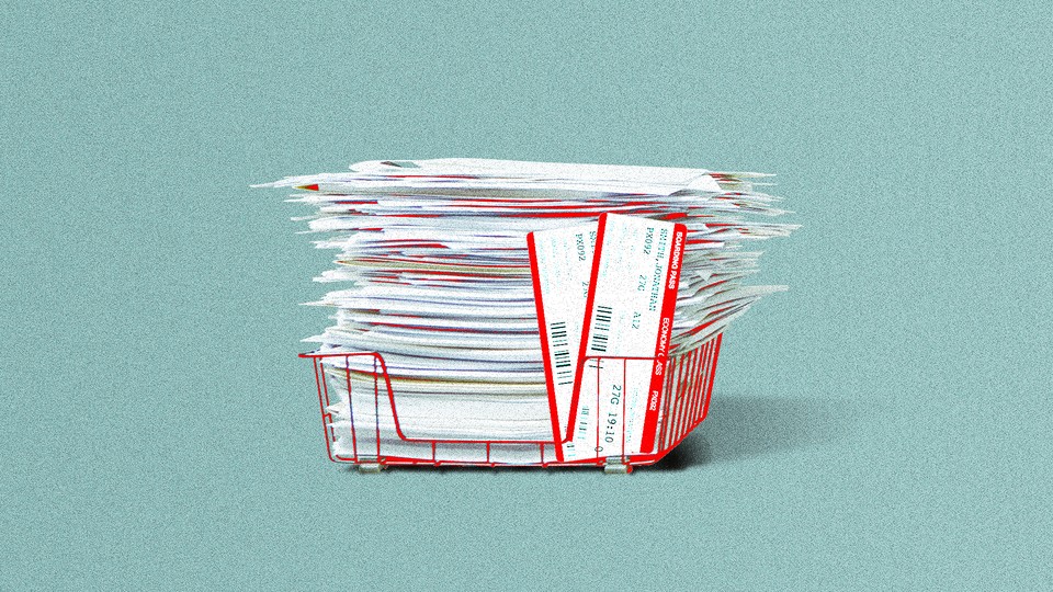 An overflowing tray of file folders with two plane tickets sticking out of it