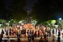 Charlottesville community members are seen leaving candles at the base of a statue of Thomas Jefferson.