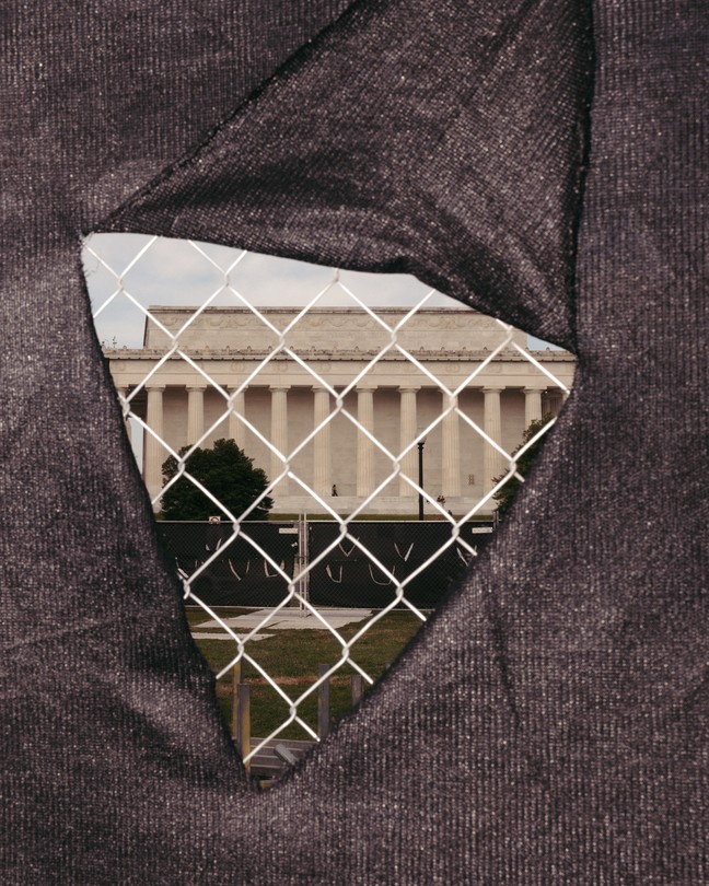 a view of the Lincoln Memorial through a construction fence