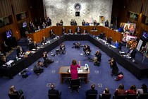 Judge Amy Coney Barrett stands with her hand raised before the Senate Judiciary Committee.