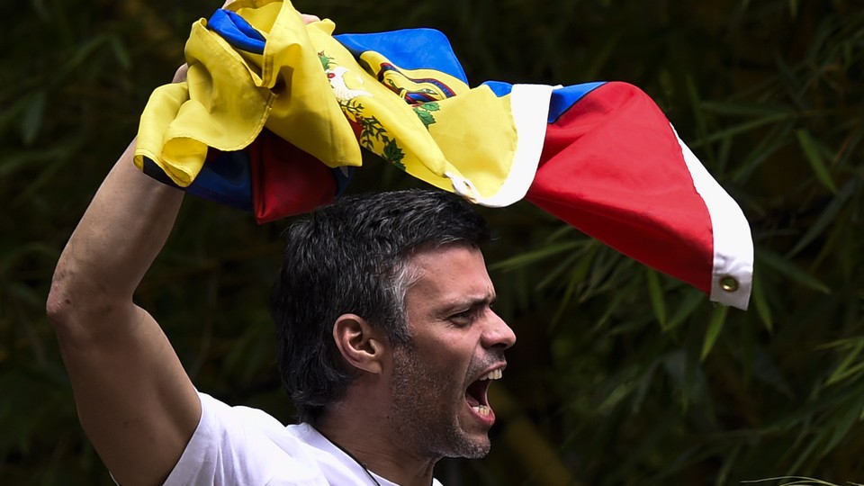 Leopoldo López displays the Venezuelan national flag.