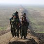 Female fighters of the Kurdish People's Protection Units (YPG) stand near the border between Syria and Iraq, December 22, 2014. 