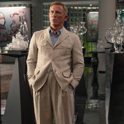 Jessica Henwick, Daniel Craig, and Janelle Monáe stand in a gallery space in "Glass Onion"