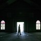 A man walks inside an empty church in the Ninth Ward area in New Orleans