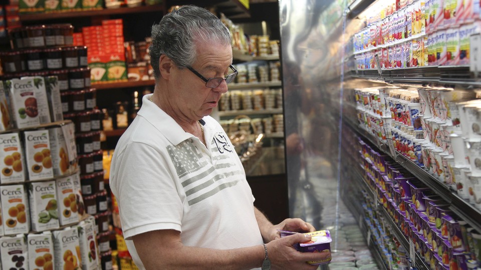 An elderly man shops for groceries