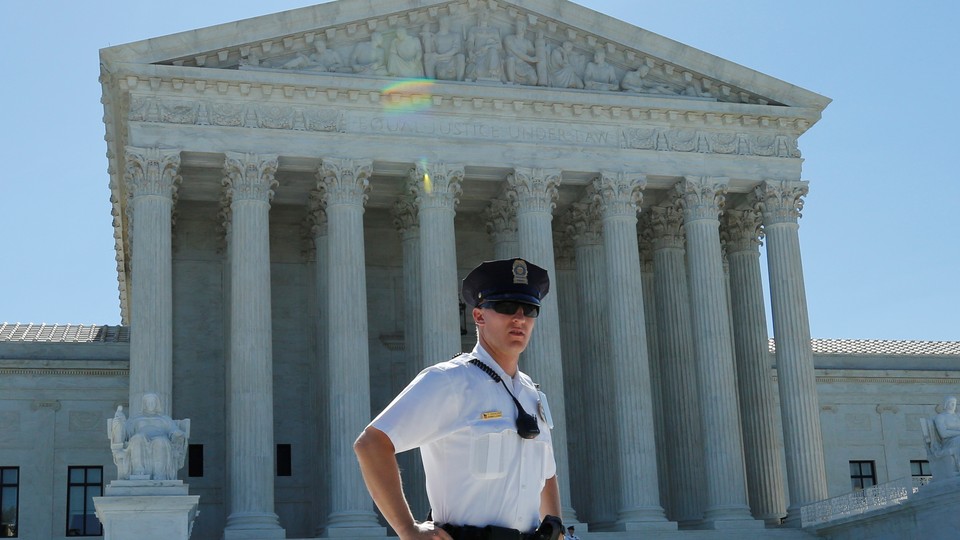 A police officer stands outside the U.S. Supreme Court building