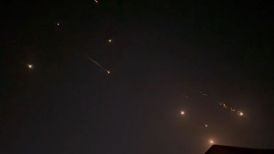 Iranian projectiles streak across the night sky.